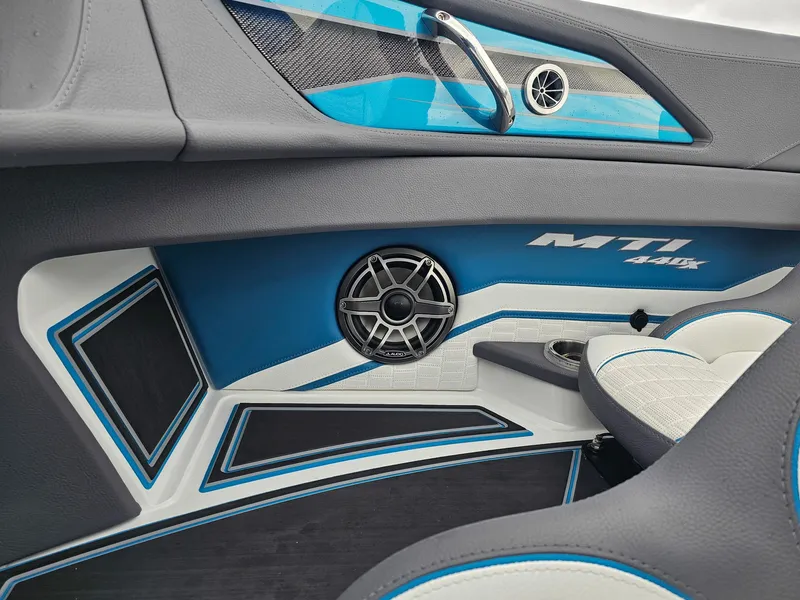 Slide: The Image of Interior of 2026 MTI 440X boat with sleek design and speaker system. - 25