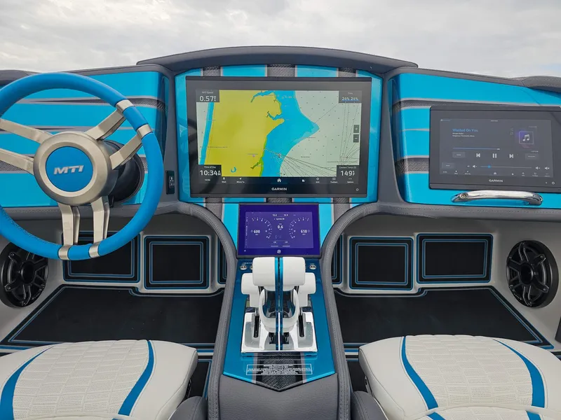 Slide: The Image of Dashboard of 2026 MTI 440X boat with navigation and control screens, blue accents. - 28