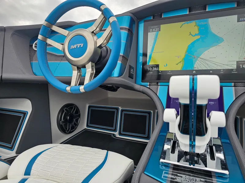 Slide: The Image of Futuristic MTI 440X boat dashboard with advanced navigation system, blue accents, and modern controls, 2026 model. - 32