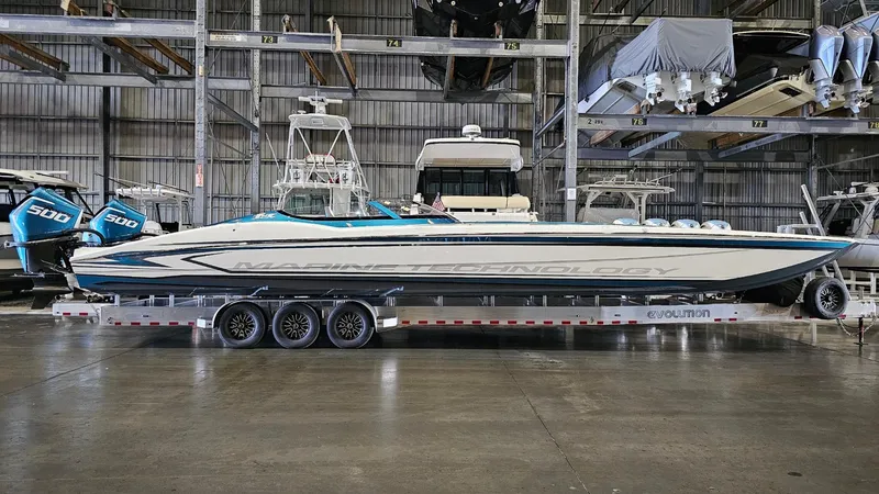 Slide: The Image of 2026 MTI 440X powerboat on trailer in indoor storage facility. - 42