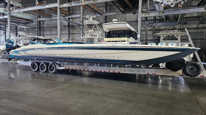 Slide: The Image of 2026 MTI 440X boat on trailer in warehouse setting. - 44