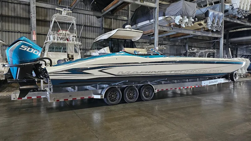 Slide: The Image of 2026 MTI 440X powerboat with 500 horsepower engine on trailer in warehouse. - 45