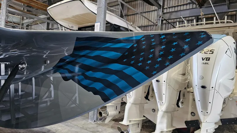 Slide: The Image of MTI 440X 2026 boat with blue-striped American flag design on the hull. - 47