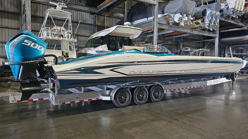 Slide: The Image of 2026 MTI 440X powerboat on trailer in a warehouse setting. - 48