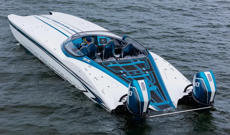 Slide: The Image of 2026 MTI 440X speedboat with dual engines on open water. - 5