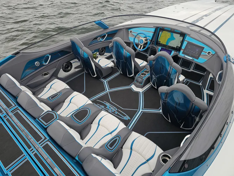Slide: The Image of Interior of a 2026 MTI 440X speedboat with modern seating and advanced navigation systems. - 8