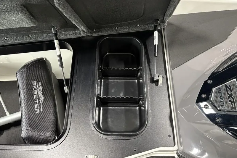 Slide: The Image of 2025 Skeeter ZXR20 boat storage compartment with hydraulic lift and branded seat. - 10