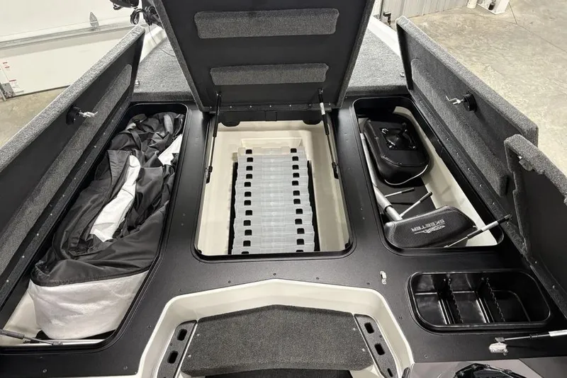 Slide: The Image of 2025 Skeeter ZXR20 boat storage compartments with open lids, showcasing organized interior space. - 14