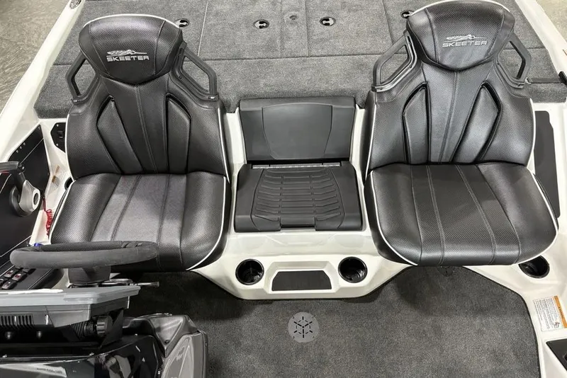Slide: The Image of 2025 Skeeter ZXR20 boat interior with two black seats and a central console. - 17