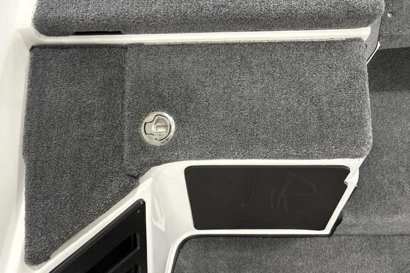 Slide: The Image of 2025 Skeeter ZXR20 boat interior with gray carpet and storage compartment. - 18