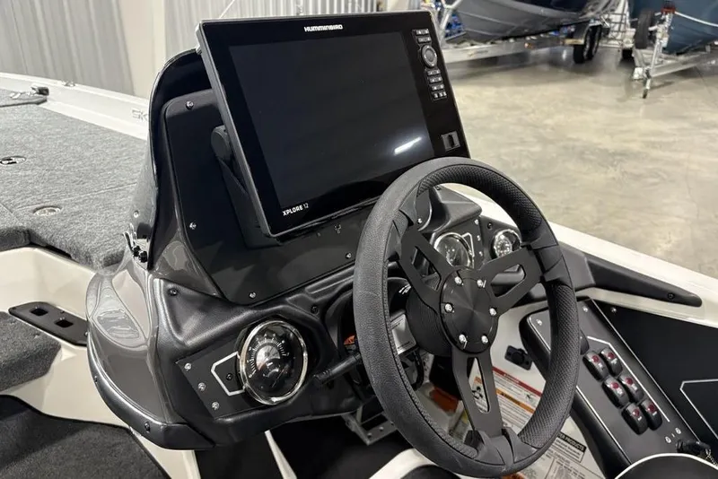 Slide: The Image of 2025 Skeeter ZXR20 boat dashboard with steering wheel and Humminbird Xplore 12 display. - 20
