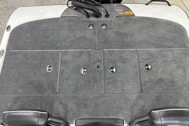 Slide: The Image of 2025 Skeeter ZXR20 boat deck with gray carpet and storage compartments. - 25