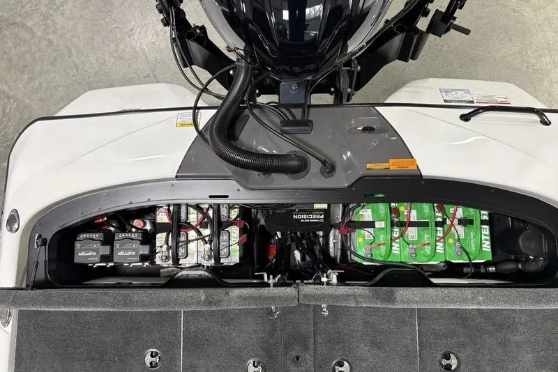 Slide: The Image of 2025 Skeeter ZXR20 boat battery compartment with multiple batteries and wiring. - 26