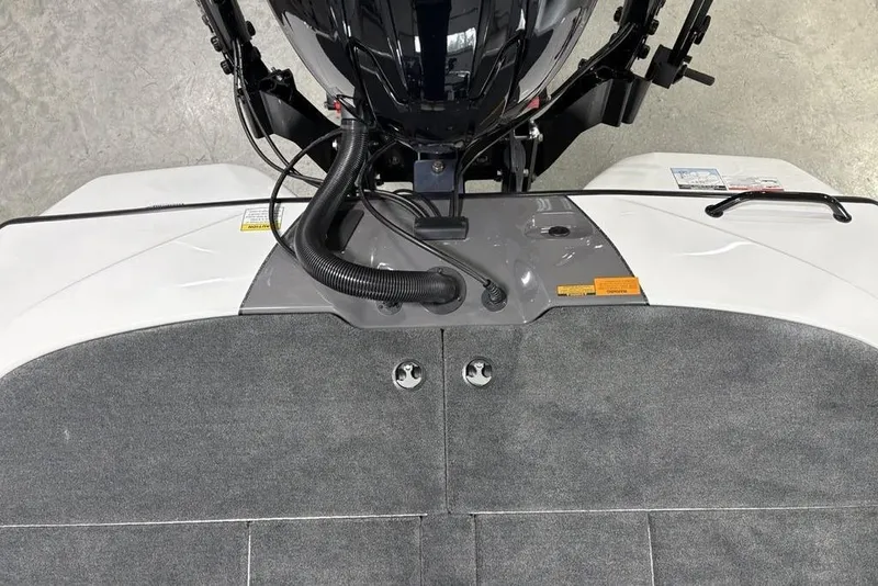 Slide: The Image of 2025 Skeeter ZXR20 boat deck with motor and carpeted surface. - 27