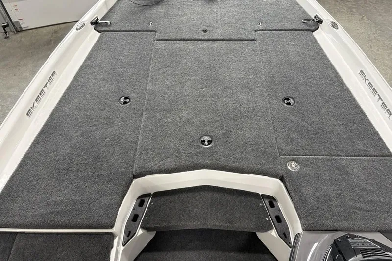 Slide: The Image of 2025 Skeeter ZXR20 boat deck with gray carpeting and storage compartments. - 5