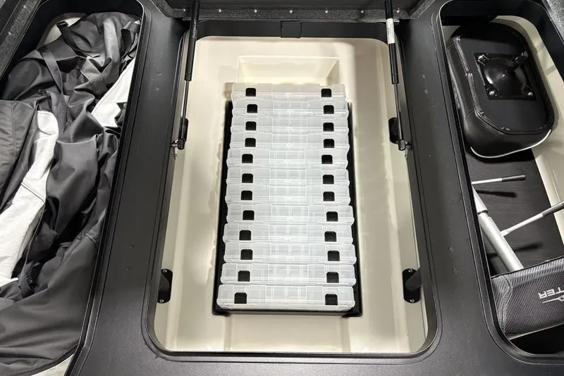 Slide: The Image of Storage compartment of 2025 Skeeter ZXR20 boat with organized tackle boxes. - 9