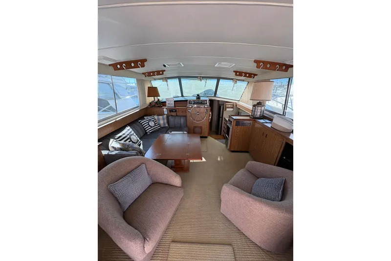 Slide: The Image of Interior of 1987 Bertram 46.6 yacht with cozy seating and nautical decor. - 17