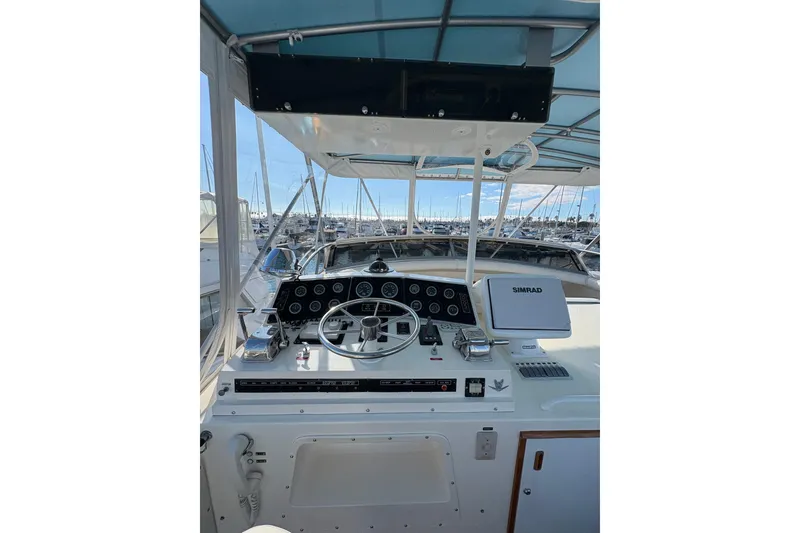 Slide: The Image of Cockpit of 1987 Bertram 46.6 yacht with steering wheel and navigation equipment. - 23