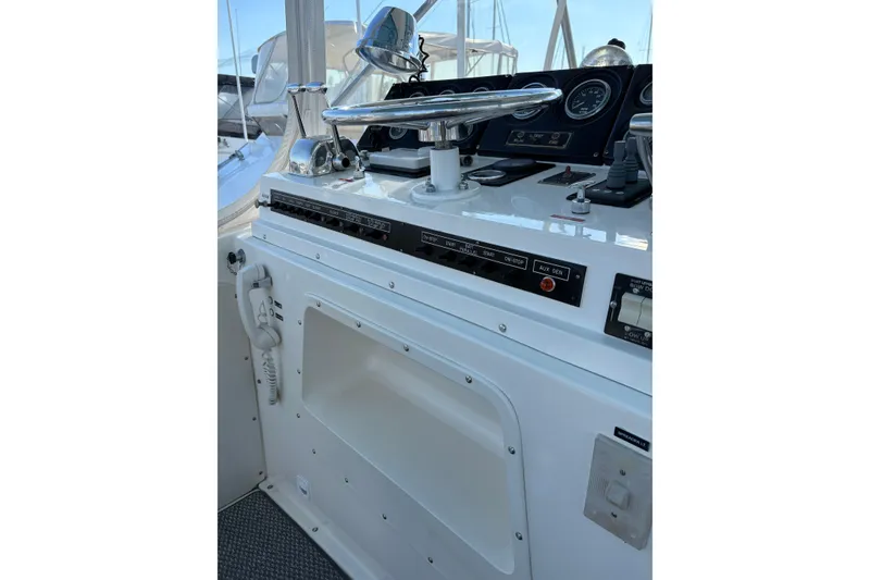 Slide: The Image of Control panel of a 1987 Bertram 46.6 yacht, featuring steering and navigation instruments. - 25