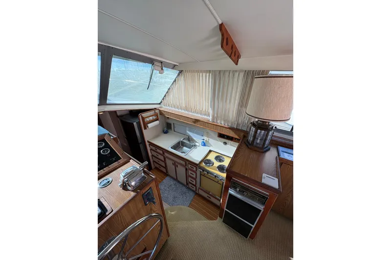 Slide: The Image of Interior of 1987 Bertram 46.6 yacht with kitchen and steering area. - 27
