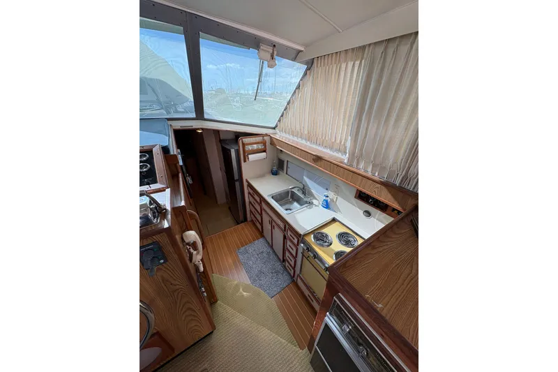 Slide: The Image of Interior of 1987 Bertram 46.6 yacht with kitchen and wooden cabinetry. - 28