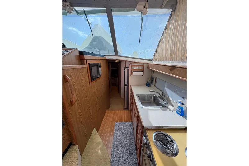 Slide: The Image of Interior of 1987 Bertram 46.6 yacht featuring kitchen area with sink and stove. - 29