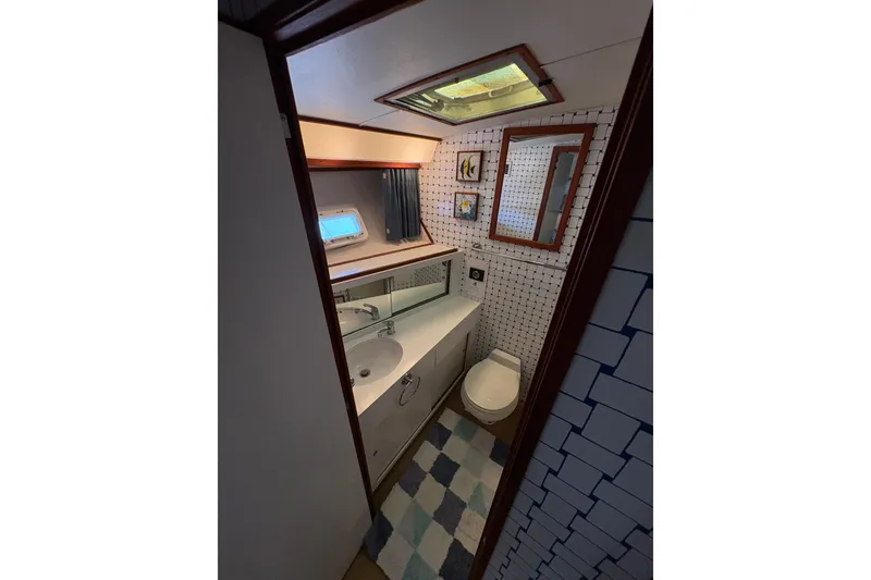 Slide: The Image of Bathroom interior of 1987 Bertram 46.6 yacht with modern fixtures and nautical decor. - 36