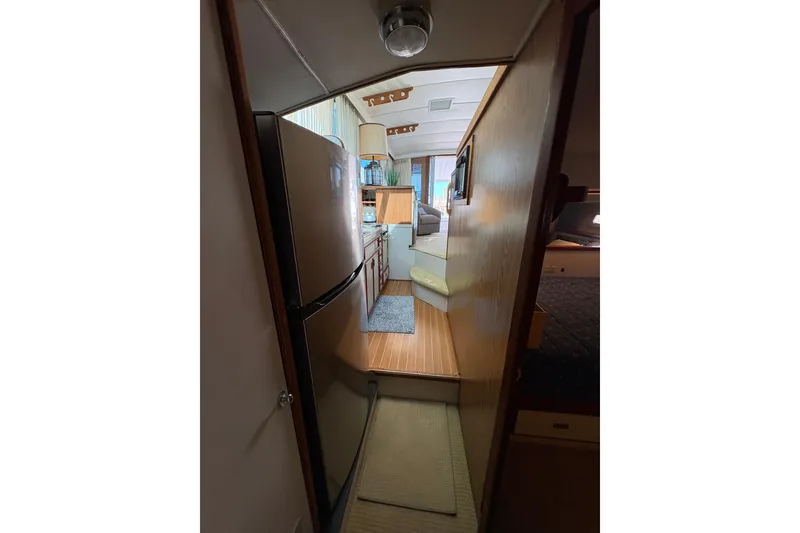 Slide: The Image of Interior view of 1987 Bertram 46.6 yacht, featuring kitchen and living area. - 43