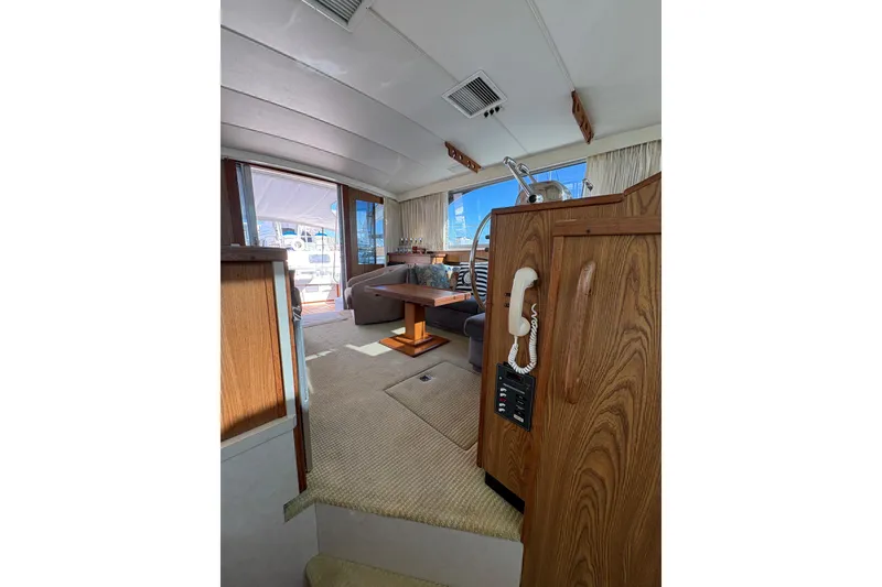 Slide: The Image of Interior of 1987 Bertram 46.6 yacht with wood paneling and seating area. - 45