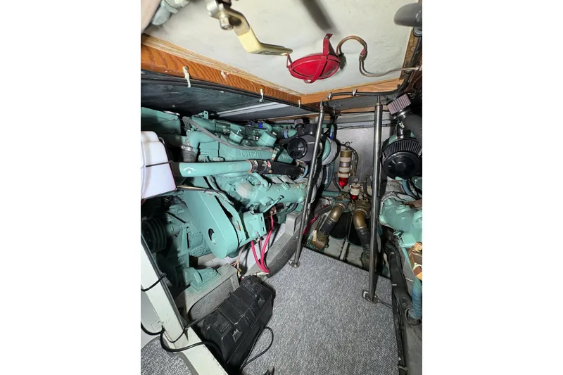 Slide: The Image of Engine room of a 1987 Bertram 46.6 yacht, showcasing mechanical components. - 47