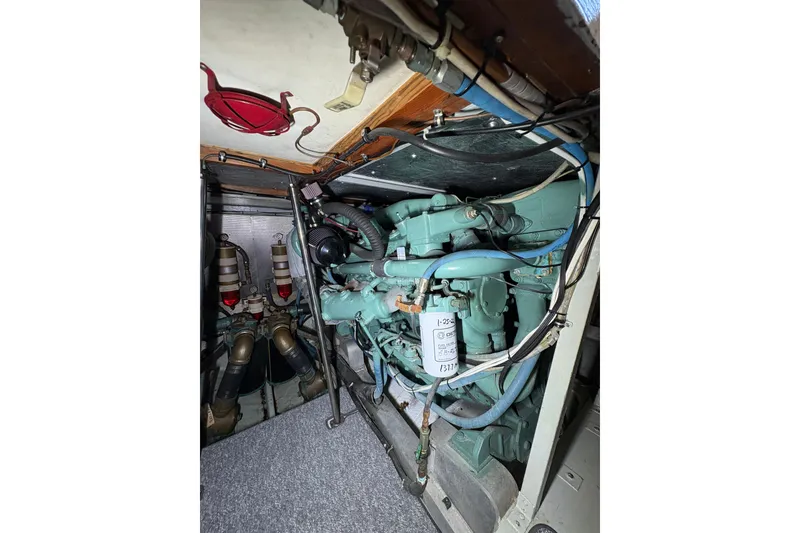 Slide: The Image of Engine room of a 1987 Bertram 46.6 yacht, showcasing mechanical components. - 48