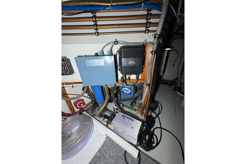Slide: The Image of Electrical components and wiring inside a 1987 Bertram 46.6 boat. - 50