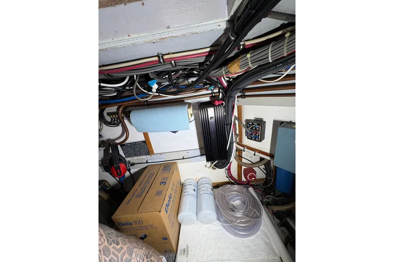 Slide: The Image of Engine room of 1987 Bertram 46.6 yacht with wiring, oil box, and filters. - 51