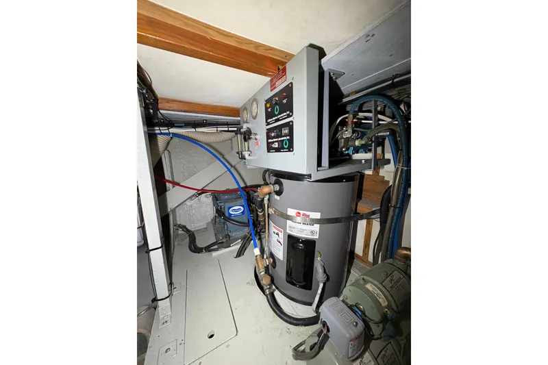 Slide: The Image of Engine room of a 1987 Bertram 46.6 yacht with mechanical equipment. - 54