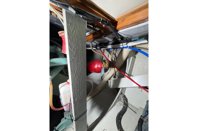 Slide: The Image of Engine room of a 1987 Bertram 46.6 yacht, showing hoses and equipment. - 55