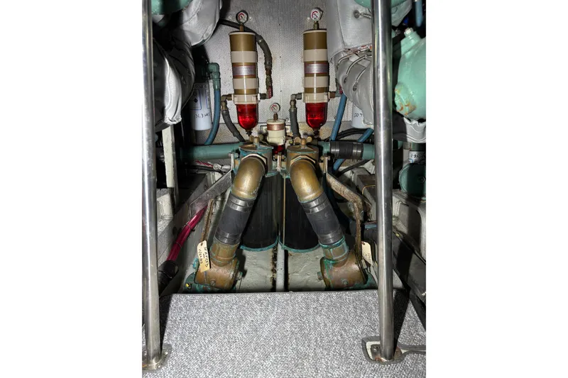 Slide: The Image of Engine room of a 1987 Bertram 46.6 yacht, showcasing mechanical components. - 56