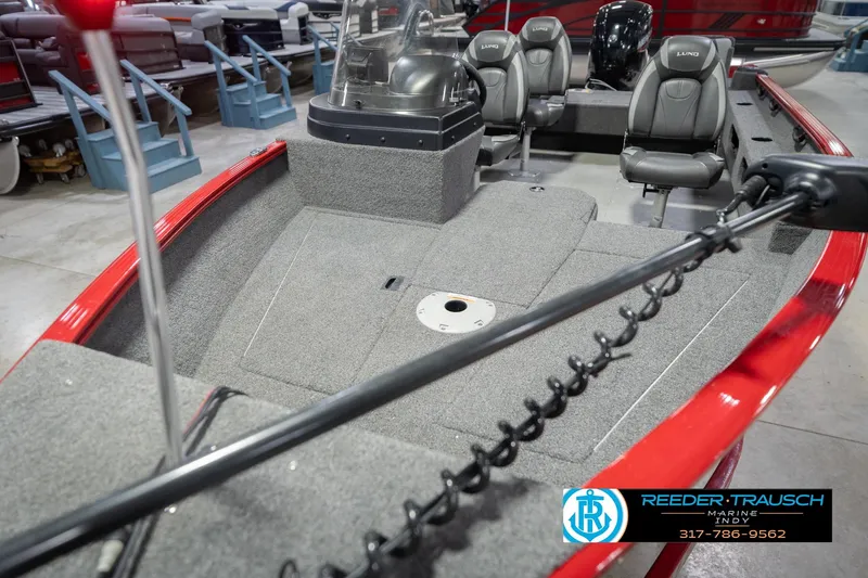 Slide: The Image of 2020 Lund 1775 Adventure SS boat interior with gray seating and red trim in showroom. - 10