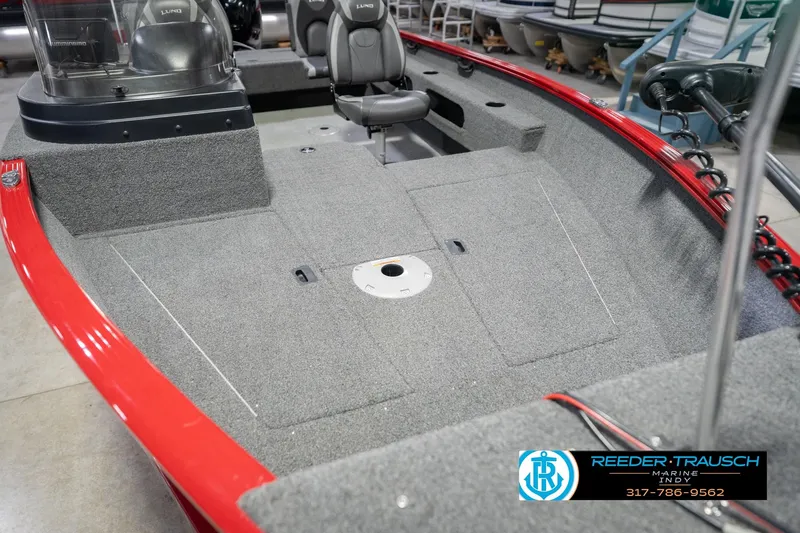 Slide: The Image of 2020 Lund 1775 Adventure SS boat interior with gray carpet and red trim. - 11