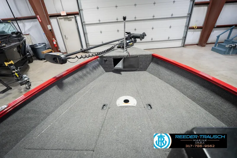 Slide: The Image of 2020 Lund 1775 Adventure SS boat interior with trolling motor in a garage setting. - 16