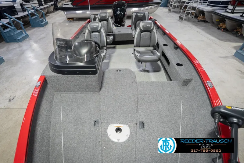 Slide: The Image of 2020 Lund 1775 Adventure SS boat interior with gray seating and red accents in showroom. - 17