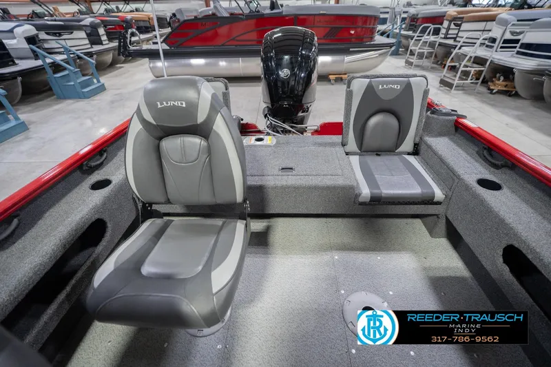 Slide: The Image of 2020 Lund 1775 Adventure SS boat interior with gray seating and motor in showroom. - 19