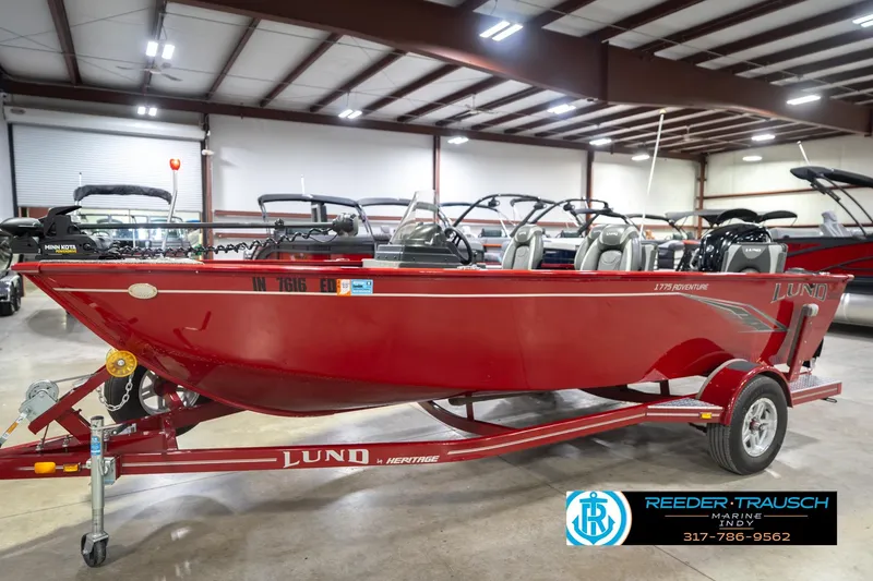 Slide: The Image of 2020 Lund 1775 Adventure SS boat in showroom, red color, on trailer. - 2