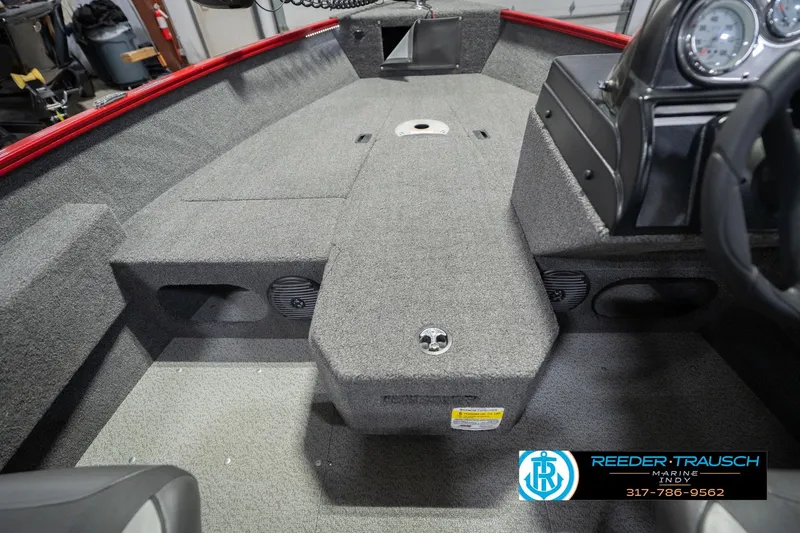 Slide: The Image of 2020 Lund 1775 Adventure SS boat interior with gray carpet and dashboard details. - 24