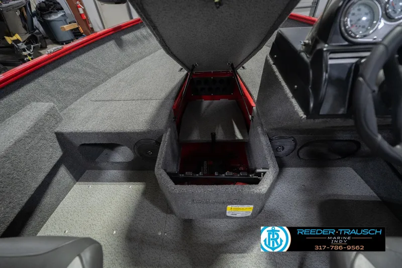 Slide: The Image of 2020 Lund 1775 Adventure SS boat interior with open storage compartment and dashboard view. - 25