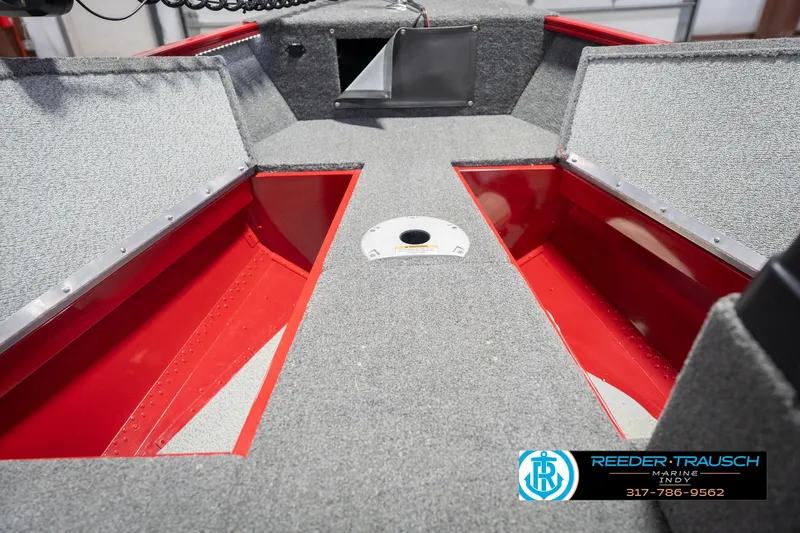 Slide: The Image of 2020 Lund 1775 Adventure SS boat interior with storage compartments and carpeted flooring. - 27