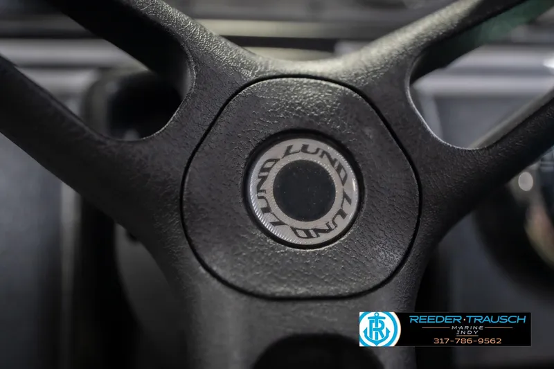 Slide: The Image of Steering wheel of 2020 Lund 1775 Adventure SS boat, featuring brand logo. - 30