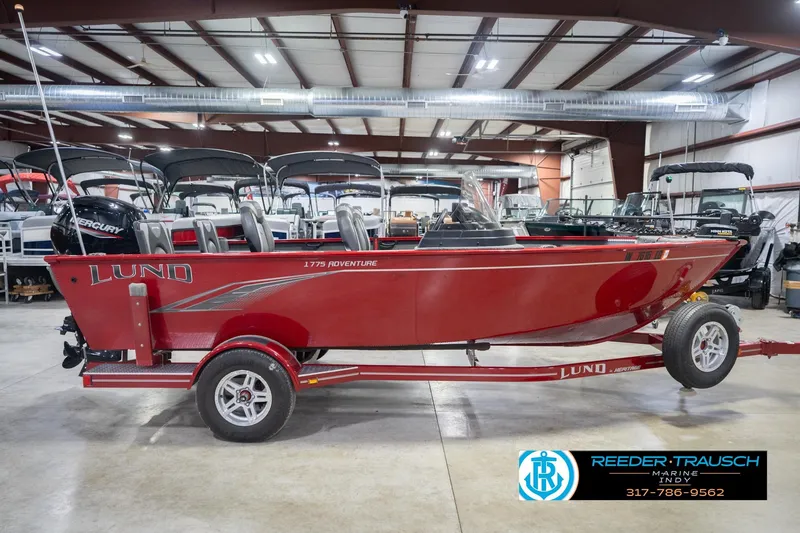 Slide: The Image of 2020 Lund 1775 Adventure SS boat in showroom, red exterior, on trailer. - 5