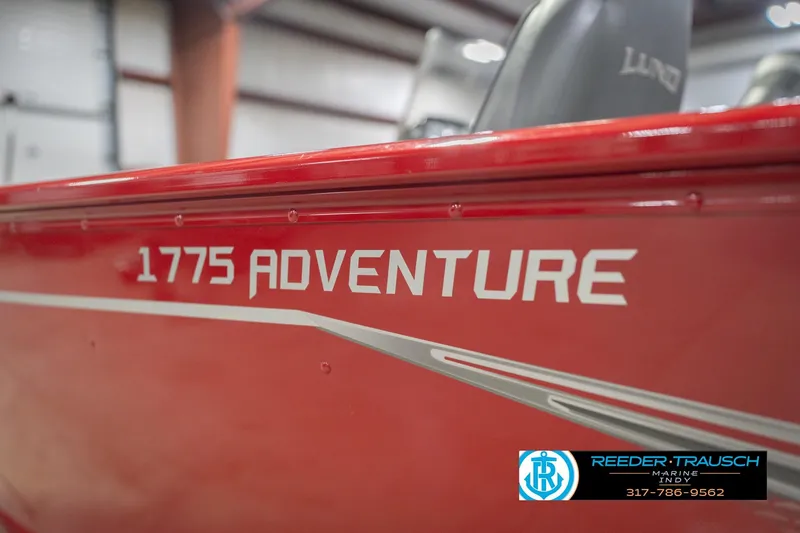 Slide: The Image of Red 2020 Lund 1775 Adventure SS boat with branding in a showroom. - 54