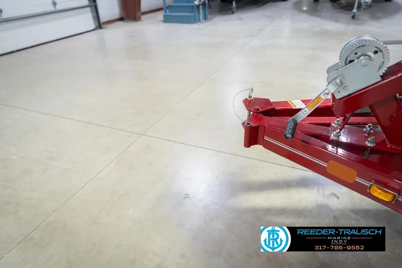 Slide: The Image of Red trailer hitch in a garage, part of a 2020 Lund 1775 Adventure SS boat. - 56