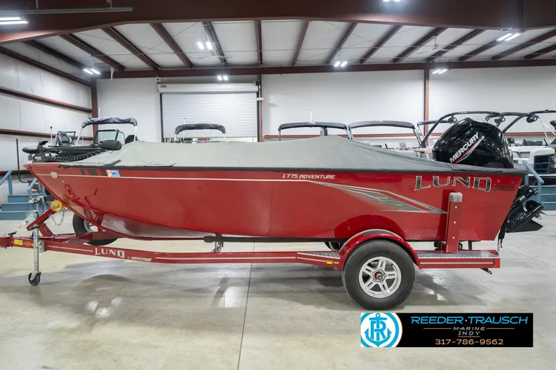 Slide: The Image of 2020 Lund 1775 Adventure SS boat in a showroom, covered and on a trailer. - 59